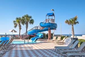 a blue water slide next to a swimming pool at The Oasis At Orange Beach 2215 by Liquid Life in Orange Beach