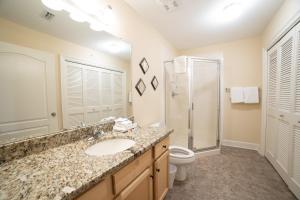 a bathroom with a sink and a toilet and a shower at The Oasis At Orange Beach 2215 by Liquid Life in Orange Beach