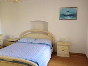 a bedroom with a bed and two night stands at Apartman Iris in Gabonjin