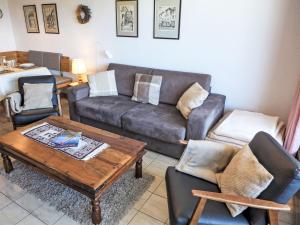 a living room with a couch and a table and chairs at Apartment Jeanne D'Arc Apt- H2-49 by Interhome in Crans-Montana