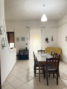 a dining room with a table and chairs at Parvis home in Brindisi