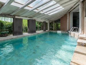 an indoor swimming pool with a ceiling with blue water at Holiday Home Antico Borgo del Riondino by Interhome in Trezzo Tinella