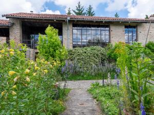 a garden in front of a house with flowers at Holiday Home Antico Borgo del Riondino by Interhome in Trezzo Tinella