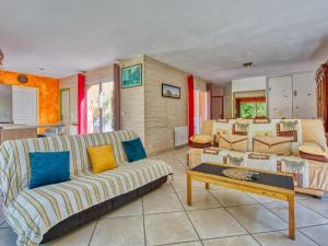 a living room with a couch and a table at Holiday Home Tina by Interhome in Naujac-sur-Mer