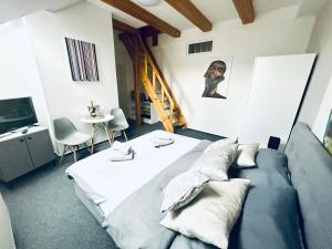 a room with a bed and a couch and a table at Penzión BACH in Vyšné Ružbachy