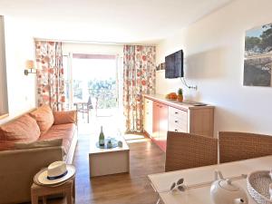 a living room with a couch and a table at Apartment L'Esquinade - FH205 by Interhome in Agay - Saint Raphael