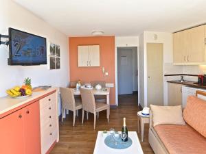 a kitchen and living room with a table and a couch at Apartment L'Esquinade - FH205 by Interhome in Agay - Saint Raphael +47 photos