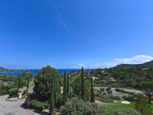 a view of a park with cypress trees and the ocean at Apartment L'Esquinade - FH205 by Interhome in Agay - Saint Raphael