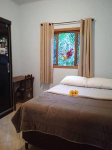 Postel nebo postele na pokoji v ubytování Casa da Rua do Coreto do Capão