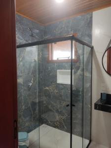 a shower with a glass door in a bathroom at Urubici Maravilhas da Serra 2 in Urubici
