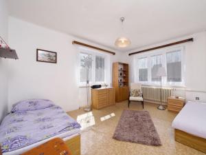 a bedroom with a bed and a desk and windows at Holiday Home Neurazy by Interhome in Neurazy