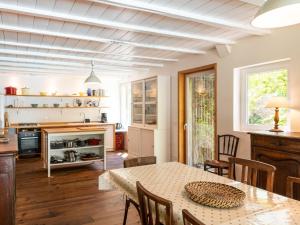 a kitchen and dining room with a table and chairs at Holiday Home La Grange du Belon by Interhome in Saint-Julien-en-Born +29 photos