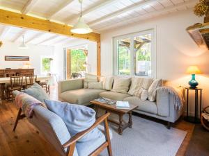 a living room with a couch and a table at Holiday Home La Grange du Belon by Interhome in Saint-Julien-en-Born