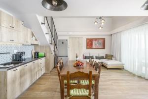 a kitchen and dining room with a table and chairs at New Villa Paradosiako with private pool and BBQ near to the Beach in Sellía