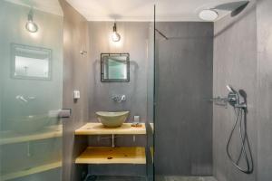 a bathroom with a sink and a glass shower at New Villa Paradosiako with private pool and BBQ near to the Beach in Sellía