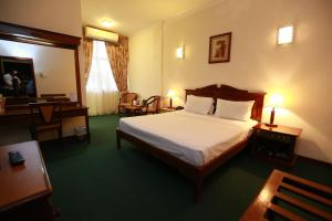 a hotel room with a bed and a desk and chair at Hotel Sapphire in Colombo +63 photos