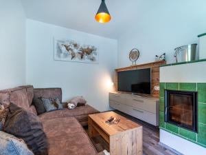 a living room with a couch and a tv at Holiday Home Sonnenteich-Haus by Interhome in Goritschach +42 photos