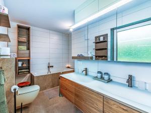 a bathroom with a sink and a toilet and a tub at Holiday Home Sonnenteich-Haus by Interhome in Goritschach