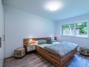 a bedroom with a bed and a window at Holiday Home Sonnenteich-Haus by Interhome in Goritschach