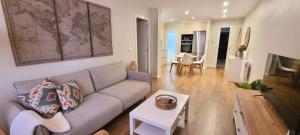 a living room with a couch and a table at Apartamento Corbaceiras in Pontevedra