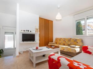 ein Wohnzimmer mit Sofa und Fernseher in der Unterkunft Holiday Home Sant Genís by Interhome in Llança