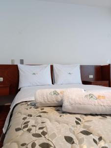 a bed with two pillows on top of it at Misky Puñuy in Chiclayo