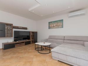 a living room with a couch and a table at Holiday Home Villa Dalmatina by Interhome in Imotski