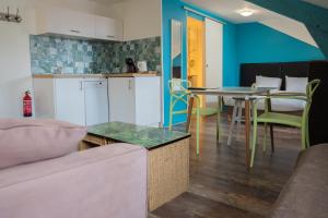a kitchen and dining room with a table and chairs at Mosaik hotel in Saint-Jean-de-Luz