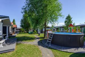 a playground with a pool and a ladder at 83 Pylimas Šventoji in Šventoji