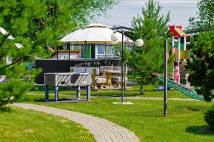 a park with a slide and a playground at 83 Pylimas Šventoji in Šventoji