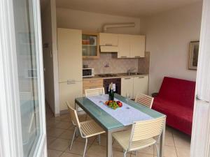 a kitchen with a table and chairs in a room at Oasi Verde 1 in Lerici +7 photos