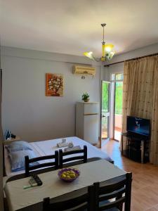 a bedroom with a bed and a table with a bowl of fruit on it at Gazi’s Apartament for Rent in Golem