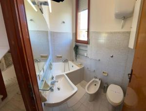 a bathroom with a sink and a toilet and a tub at 300 mt from the Sea - Free Parking - Wi-fi AC & Prime Video in Lido di Camaiore +22 photos