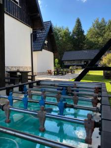 a pool with figurines in the water in front of a house at House Maka in Rudanovac