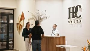 a group of people standing at a reception desk at Hotel Caseros Salta in Salta