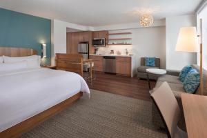 a hotel room with a bed and a kitchen at Element Toronto Airport in Mississauga
