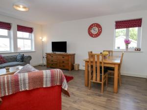 a living room with a table and a dining room at Ingle View in Carnforth