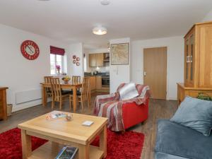 a living room with a couch and a table at Ingle View in Carnforth