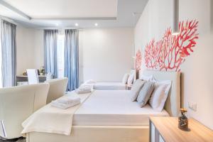 a bedroom with a large white bed with white furniture at Dei del Mare Extra Luxury in Gallipoli +86 photos