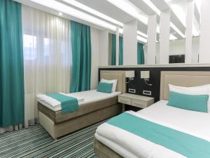Voodi või voodid majutusasutuse Hotel Prezident toas