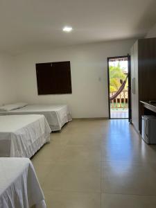 Ένα ή περισσότερα κρεβάτια σε δωμάτιο στο Pousada Bambui