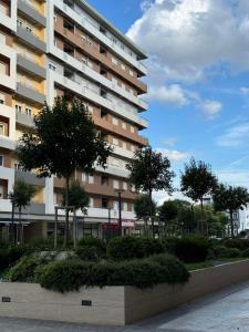 a large apartment building with trees in front of it at Apartments Central Point 11 in Podgorica