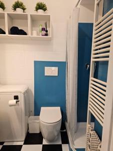 a blue bathroom with a toilet and a shower at Casa Lingotto Fiere Metro in Turin +37 photos