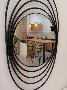 a round mirror hanging on a wall in a kitchen at Apartamento moderno junto a estación de tren in Córdoba