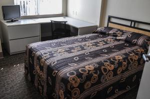 a bedroom with a bed and a desk with a computer at Residence & Conference Centre - Kitchener-Waterloo in Kitchener +12 photos