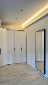 a room with white cabinets and a mirror at Ferienwohnung an der Wildenburg in Kempfeld
