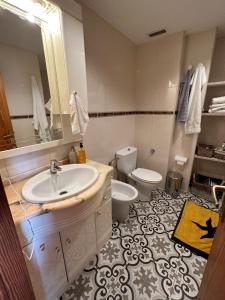 a bathroom with a sink and a toilet at Beach Apartment with Stunning View in Can Pastilla