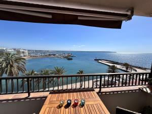 a balcony with a table with a view of the ocean at Beach Apartment with Stunning View in Can Pastilla +8 photos