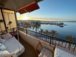 a balcony with a bed and a view of the ocean at Beach Apartment with Stunning View in Can Pastilla