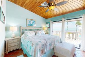 a bedroom with a bed with a view of the ocean at Big View Hideaway in Key Largo
